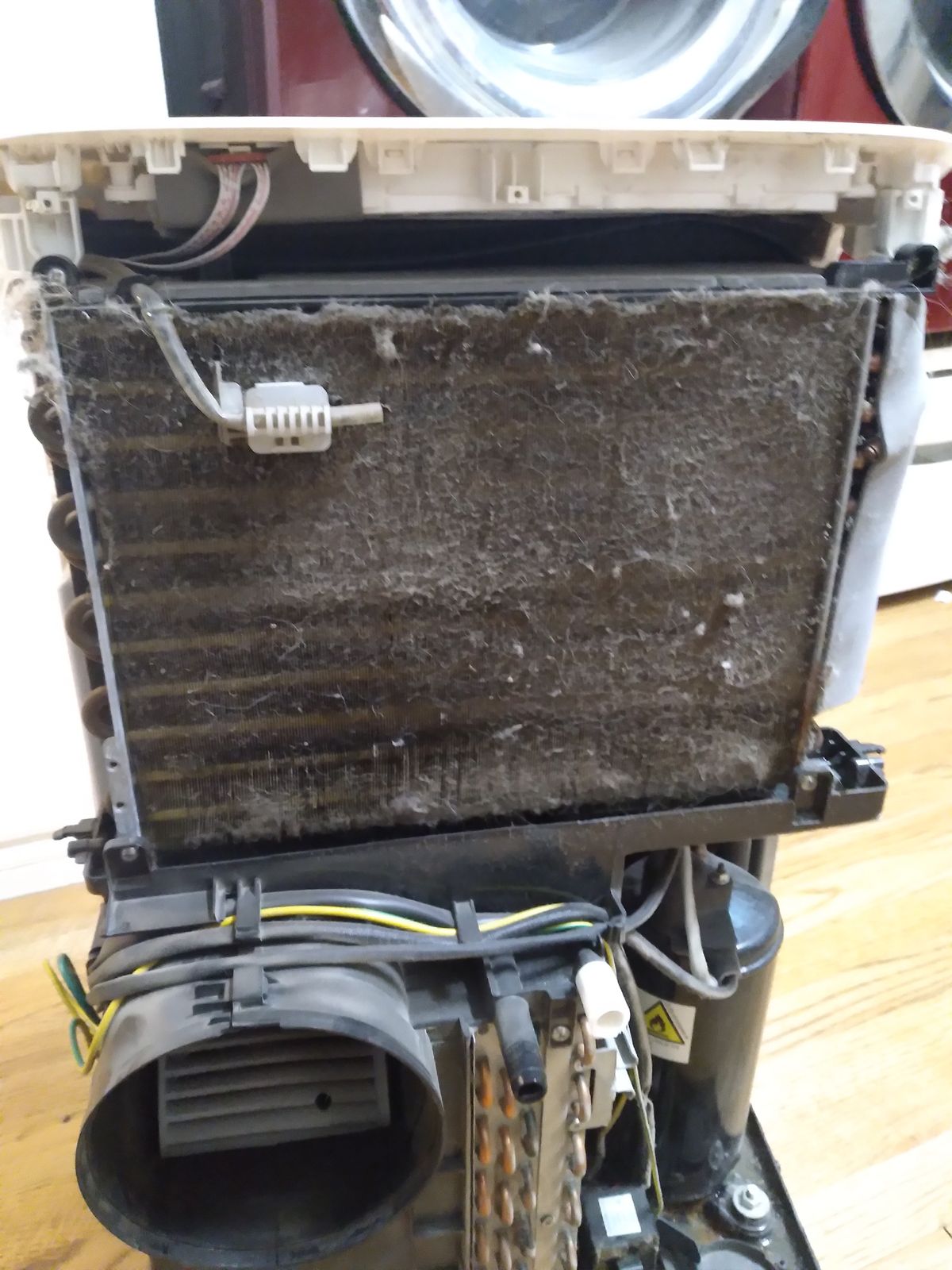 A dirty, dust-clogged HVAC filter restricting airflow before cleaning